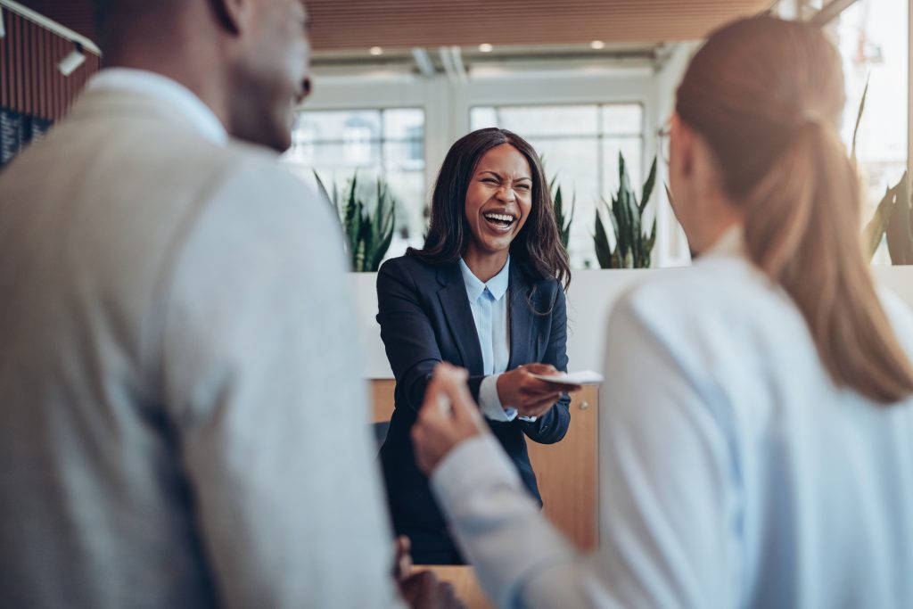 Study after study confirms that retaining customers is significantly more profitable than chasing new ones. In fact, research shows that increasing retention by just 5% can raise profits by 25% to 95% - Image of employee smiling and interacting with customers showing the importance of customer engagement