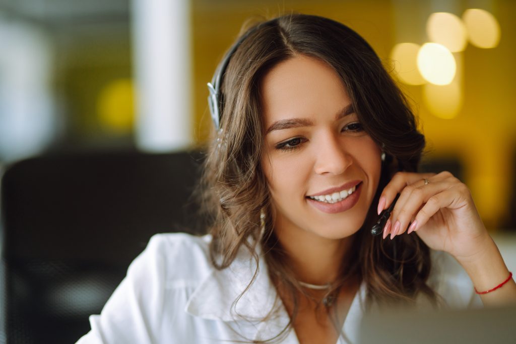 Whether you're aiming to boost sales, improve caller experience, or strengthen your customer relationships, we’re here to help you make every second count. - Employee wearing phone headset speaking to customers