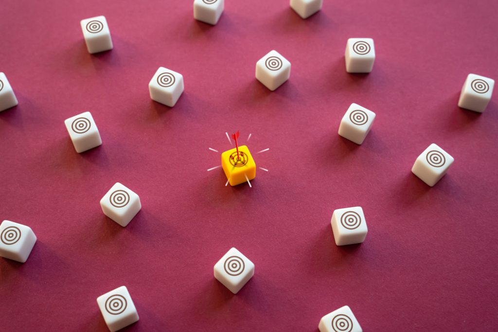 Targeted Delivery: One of pAOOH’s most compelling features is its ability to deliver hyper-relevant messages - White target blocks with one yellow target block in the center that has an arrow through it