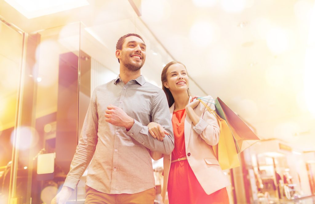 Greater Reach with Flexibility:
Unlike static billboards or posters, audio has the power to spark imagination and create lasting impressions - Couple shopping in a mall or large store looking off into the distance